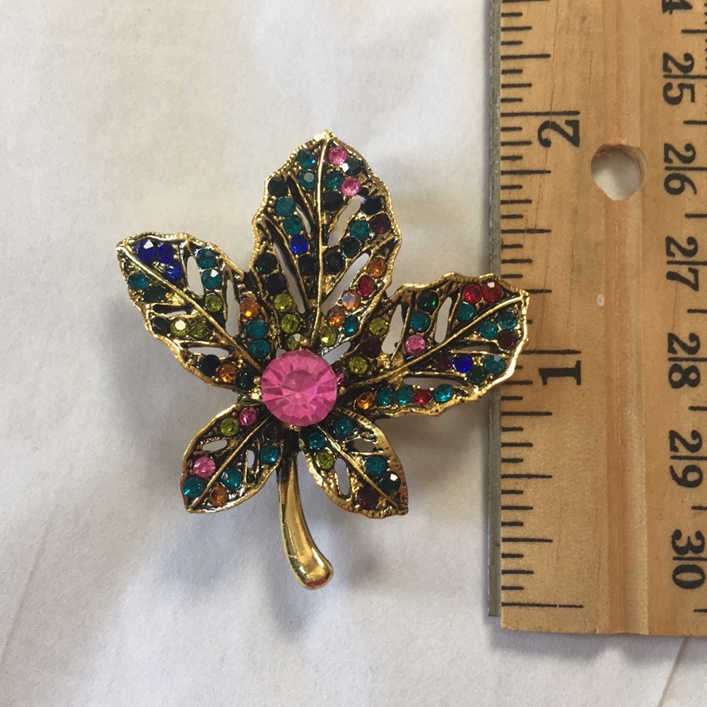 Multicolored jeweled flower gold tone brooch
